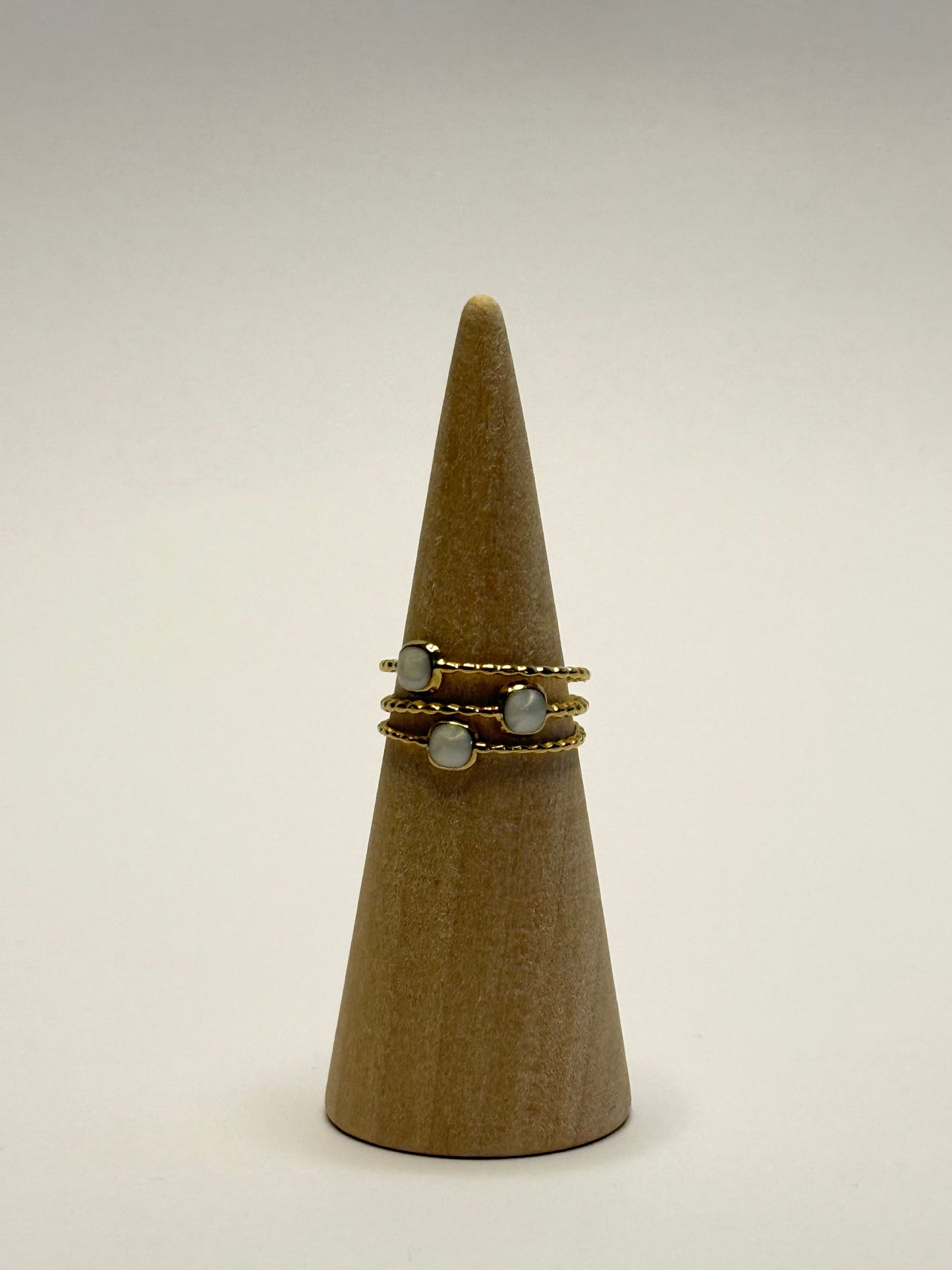 Ring on a wooden cone with a plain background