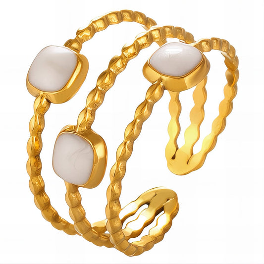 layered Gold ring with white stones on a white background