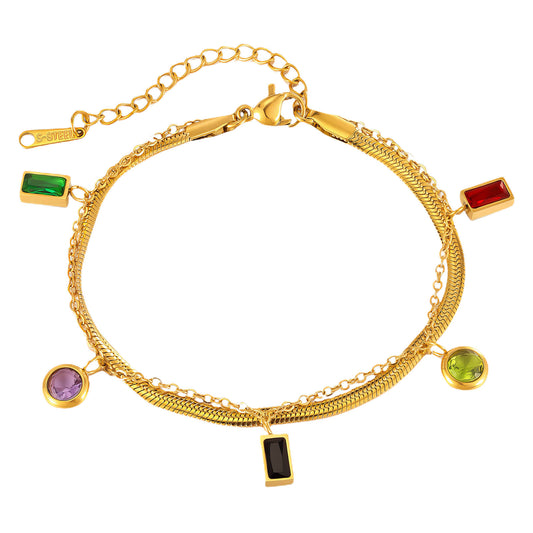 Gold bracelet with colorful gemstone charms on a white background