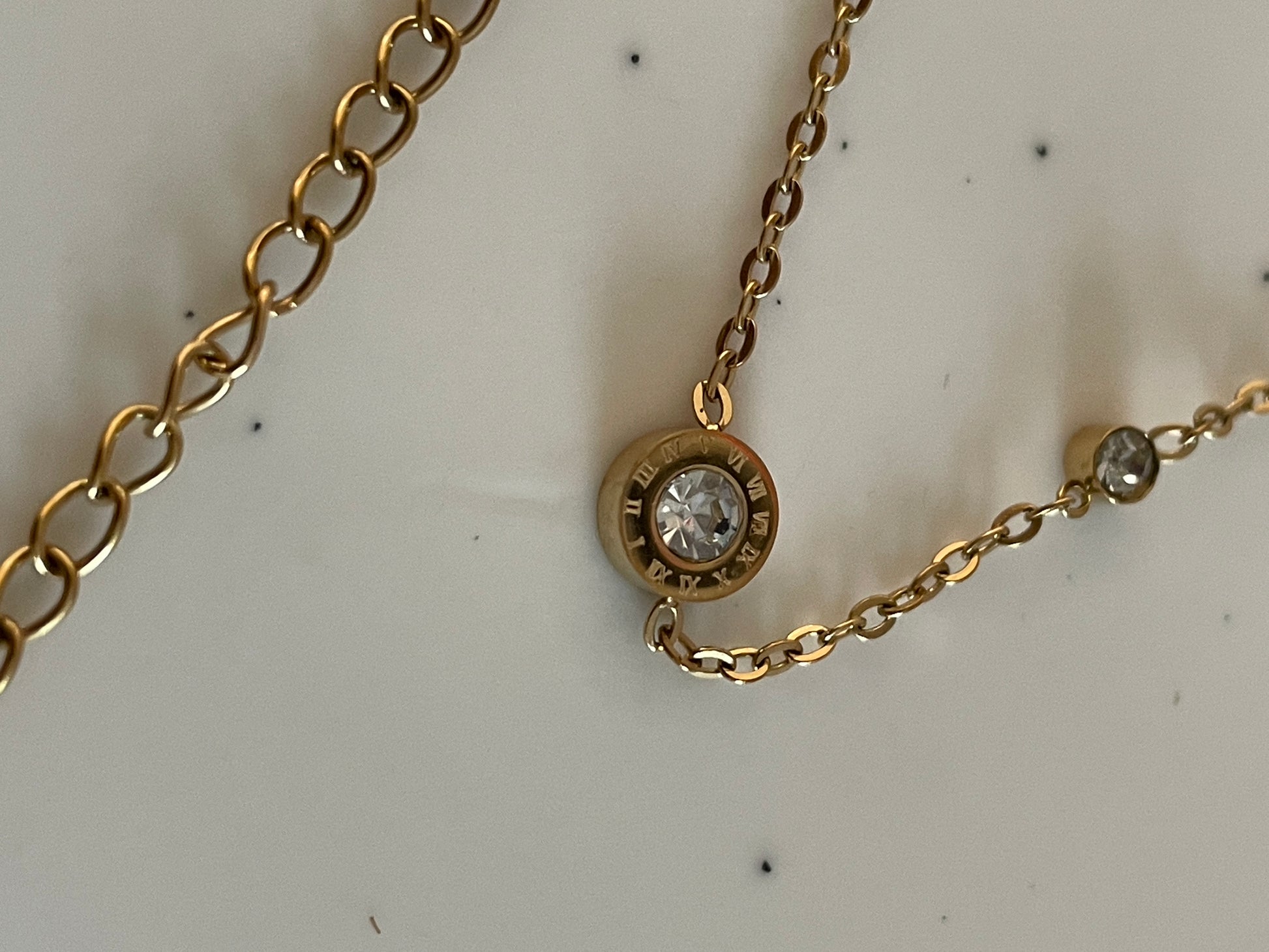 Gold Bracelet with Cubic zirconia stones on a light background