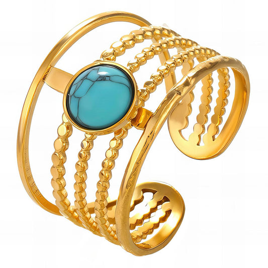 Gold Cuff ring with a turquoise stone on a white background