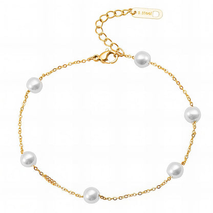 Gold bracelet with white pearls on a white background
