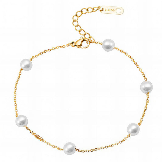 Gold bracelet with white pearls on a white background