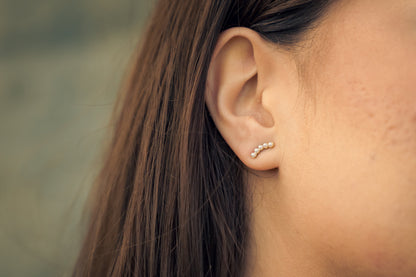 Close-up of an ear with Serene Pearl Earrings earring against a blurred background