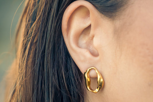 Close-up of a model wearing a Wave Aura earring 